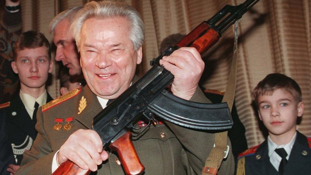 Mikhail Kalashnikov holds his famed AK-47 assault rifle