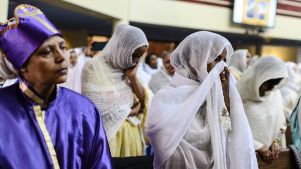 Members of the Ethiopian community take part in a special prayer for victims of the crash at the Ethiopian Orthodox Tewahedo Church of Canada Saint Mary Cathedral in Toronto on Sunday.