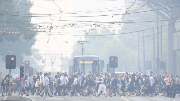Commuters in Melbourne confront severe smoke haze on Tuesday. 