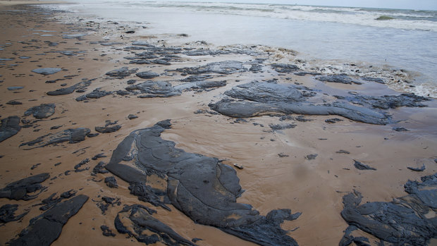 Spilled oil lays on the beach on Sergipe state, Brazil.