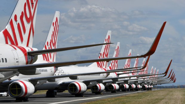 Virgin Australia planes sit dormant at Brisbane Airport, which is giving up to 100 grounded aircraft free parking.