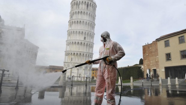 A worker carries out coronavirus sanitation operations in Pisa in 2020. The pandemic has created new opportunities for Italy’s organised crime.