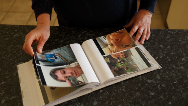 Michelle Degenhardt flips through a family photo album.
