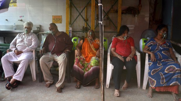 COVID-19 patients receive oxygen outside a Gurdwara, a Sikh house of worship, in New Delhi, India.