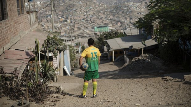 A football player looks over Pamplona shanty town in Lima, Peru, on March 13.