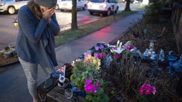 Rene Norton, a friend and neighbour of Damond, wipes away tears at a memorial near the alley where she was killed.