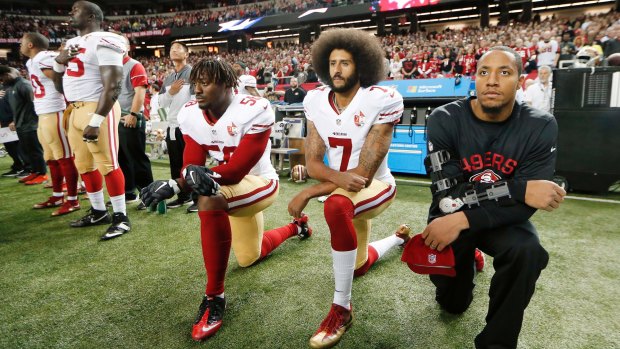 Taking a knee to make a stand: San Francisco 49ers quarterback Colin Kaepernick (7) and Eli Harold (58) kneel during the playing of the national anthem before an NFL game in 2016. 
