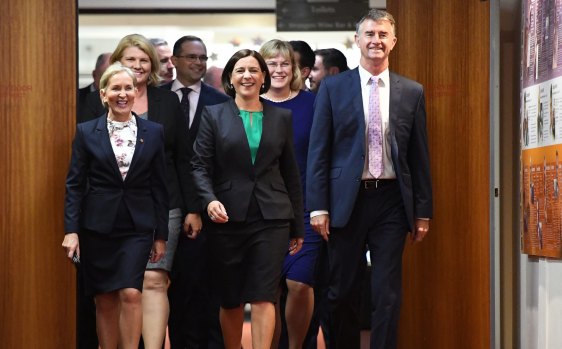 Deb Frecklington (centre) and her  deputy Tim Mander (right) walking in to a 2017 party room meeting that saw their elevations.