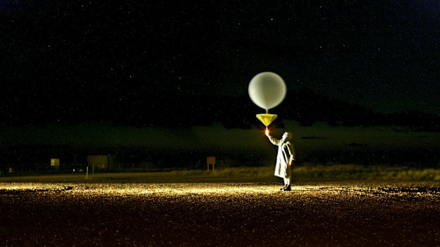 Weather observer Michael Glasson releases a weather balloon at Giles weather station in Western Australia to track wind speed and direction. The data will help predict rain in Sydney .