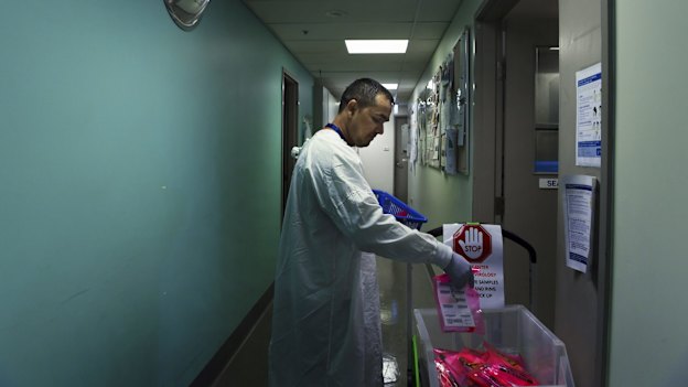 Sanjay Adhikari delivers samples that are to be tested for coronavirus at the Prince of Wales Hospital.  