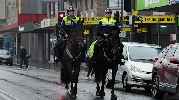 NSW mounted police patrol the streets of a locked-down Fairfield in July 2021. 