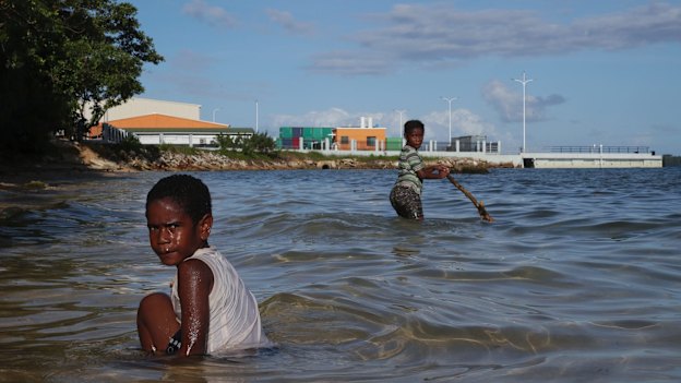 Children play near the new China-funded wharf in Luganville, Vanuatu. 