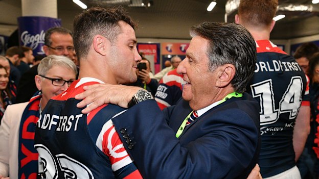Politis celebrates the Roosters’ 2018 grand final win with Cooper Cronk.