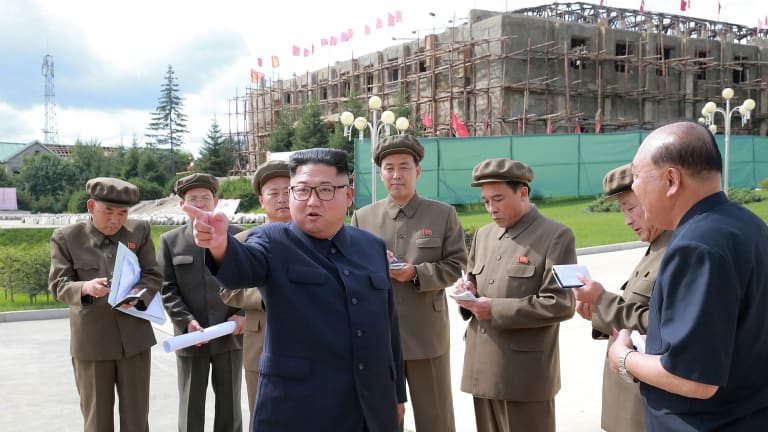 Kim Jong-un, centre, visits a construction site during a visit to the city of Samjiyon. 