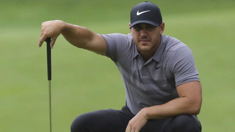 Focus: Brooks Koepka lines up a putt during a practice round for this week's Northern Trust tournament.