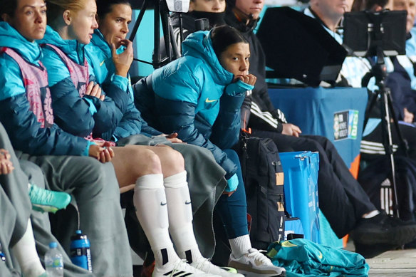 Sam Kerr watches on from the sidelines.