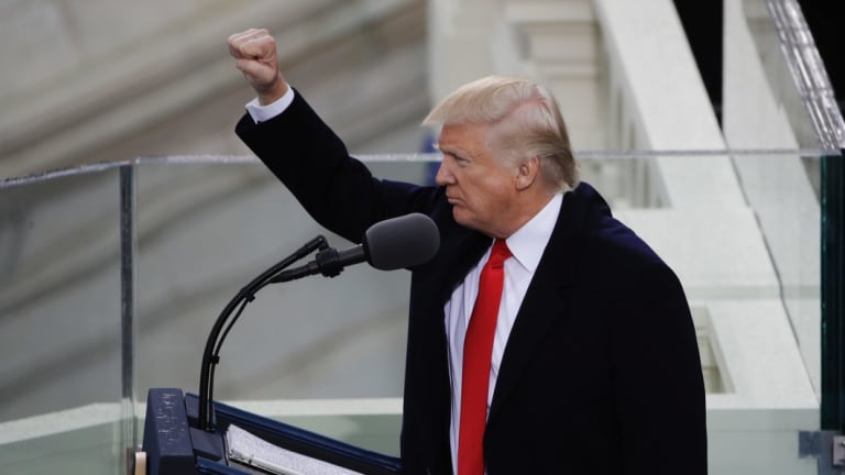 President Donald Trump pumps his fist after delivering his inaugural address.