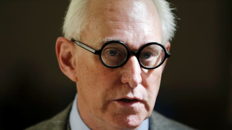 Roger Stone talks to reporters outside a courtroom in New York. 