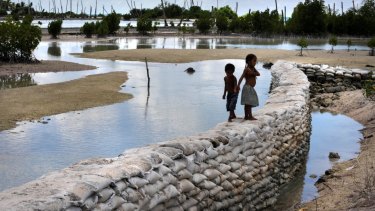A sea wall in the village of Tebunginako at low tide.