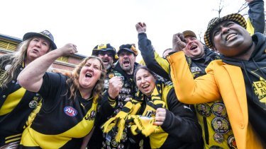 Happier times: Richmond cheer squad members before their 2017 grand final win.