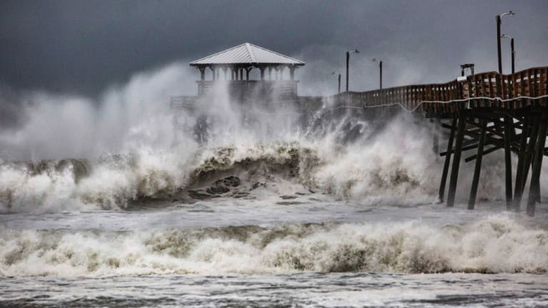 Waves slam the Pier House Restaurant in Atlantic Beach, NC, on Thursday.