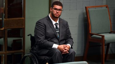 Greens Senator Jordon Steele-John listens to Prime Minister Scott Morrison move a motion in support for a royal commission into the abuse of disabled people, in the House of Representatives.