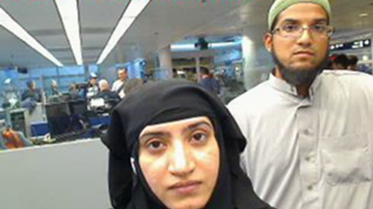 San Bernardino shooters Tashfeen Malik, left, and Syed Farook pictured passing through O'Hare Airport in Chicago in July 2014.