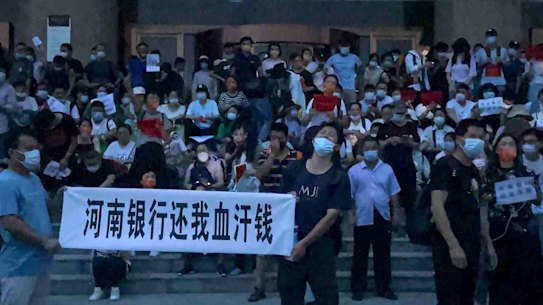 Demonstrators outside the People’s Bank of China in Zhengzhou, Henan province.
