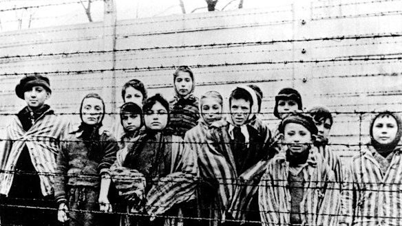This file photo, taken just after the liberation by the Soviet army in January, 1945, shows a group of children wearing Auschwitz concentration camp uniforms.