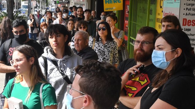 Hundreds queue outside a Centrelink office as jobs evaporate. 