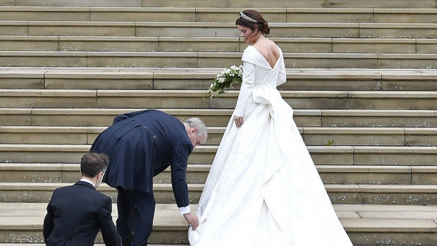 Britain's Princess Eugenie, accompanied by her father Prince Andrew, arrives for her wedding ceremony to Jack Brooksbank in St George’s Chapel, Windsor Castle on Friday.