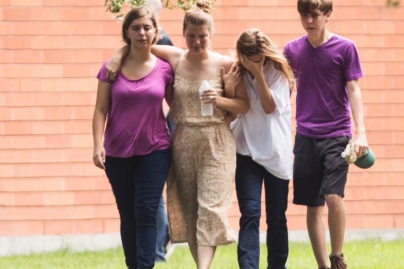 Students are emotional as they gather by the Barnett Intermediate School where parents are gathering to pick up their children following a shooting at Santa Fe High School in 2018