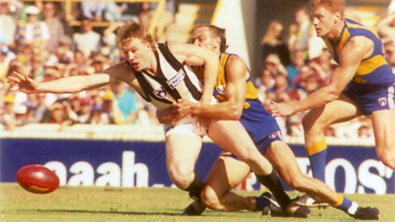 Nathan Buckley is tackled by Peter Matera during the 1994 qualifying final in Perth.