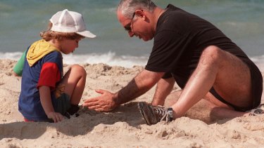 Israeli Prime Minister Benjamin Netanyahu plays in the sand with his son Yair at the beach in 1997.