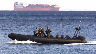 An Australian vessel patrols the waters near the Norwegian ship Tampa in 2001. 