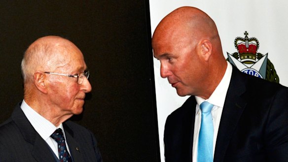 Former chief commissioner Mick Miller presents Echo Taskforce's Detective Senior Sergeant Wayne Cheesman with the 2014 detective of the year award. 