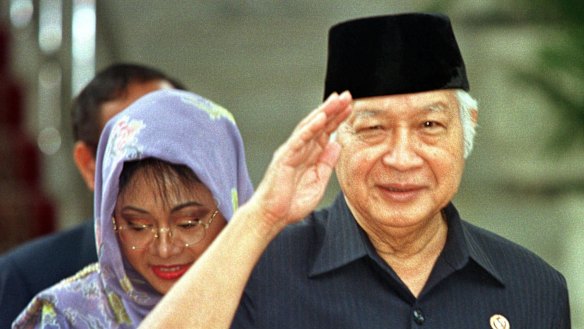 Former Indonesian President Suharto, right, salutes after announcing his resignation in 1998.