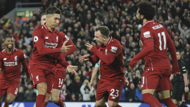 Hat-trick: Roberto Firmino (second left) celebrates with his teammates during Liverpool's big win over Arsenal.