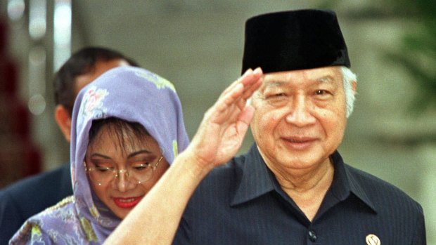Former Indonesian President Suharto, right, salutes after announcing his resignation in 1998.