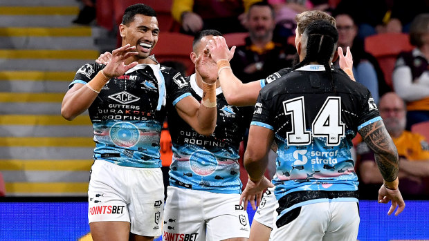 Ronaldo Mulitalo and his Sharks teammates celebrate during the win over the Broncos.
