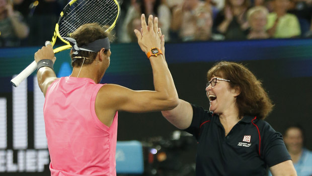 Deb Borg plays tennis alongside Rafael Nadal at Wednesday night's Rally for Relief.