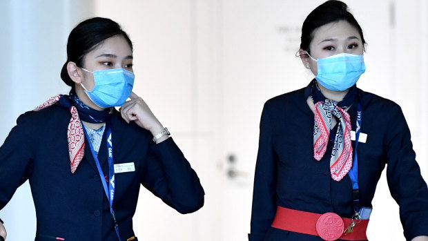 China Eastern Airlines cabin crew are seen wearing protective face masks at Brisbane International Airport.