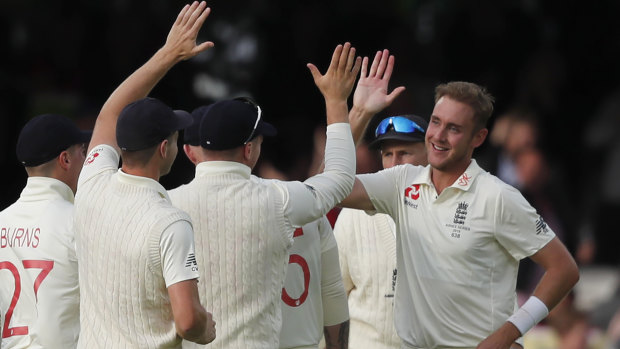 Stuart Broad, right, celebrates taking the wicket of David Warner.