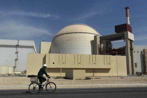 A worker travels in front of the rental power plant, just outside the southern city of Iran, in 2010.