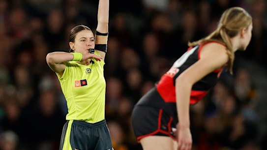 Emma Stark umpires during Saturday night’s inaugural AFLW clash between Essendon and Hawthorn.