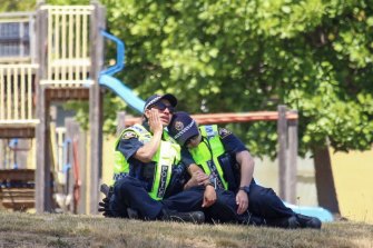 Devastated police officers at the primary school in Devonport which was the scene of a fatal jumping castle accident.