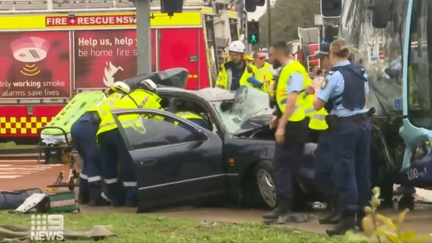 Paramedics and fire crews work to free the woman and the girl from the wreckage. 