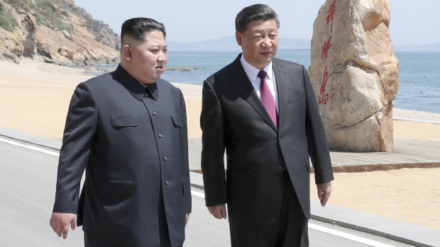 North Korean leader Kim Jong-un walks with Chinese President Xi Jinping during a meeting in Dalian.