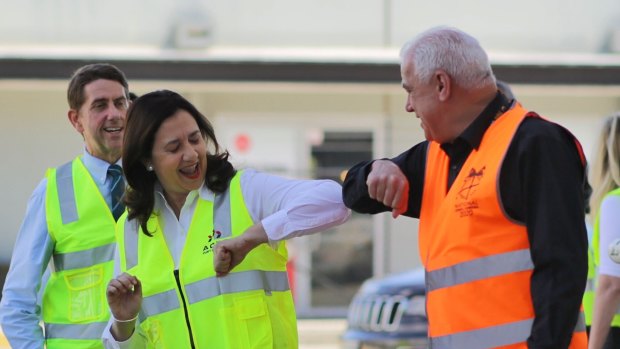 Sign of the times: Annastacia Palaszczuk  does the pandemic shake on day one of the election campaign