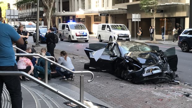 A man was being treated by paramedics after the Tesla he was driving collided with an ambulance on Ann Street.